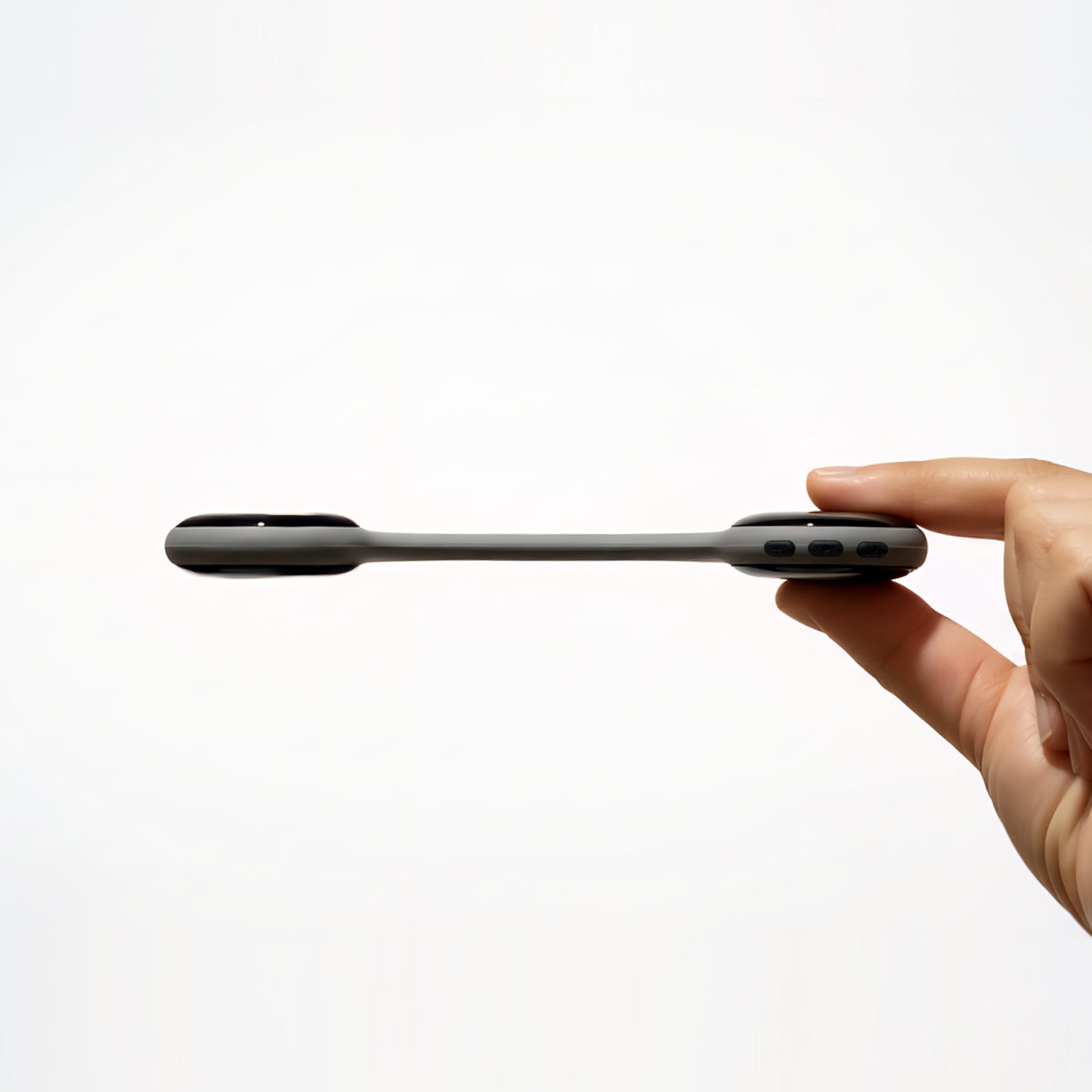 Hand holding the slim Reztful Noctune under pillow bone conduction Bluetooth speaker on a white background